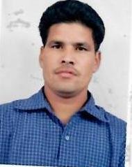Portrait of Dr. Kapoor wearing traditional attire with academic books in background